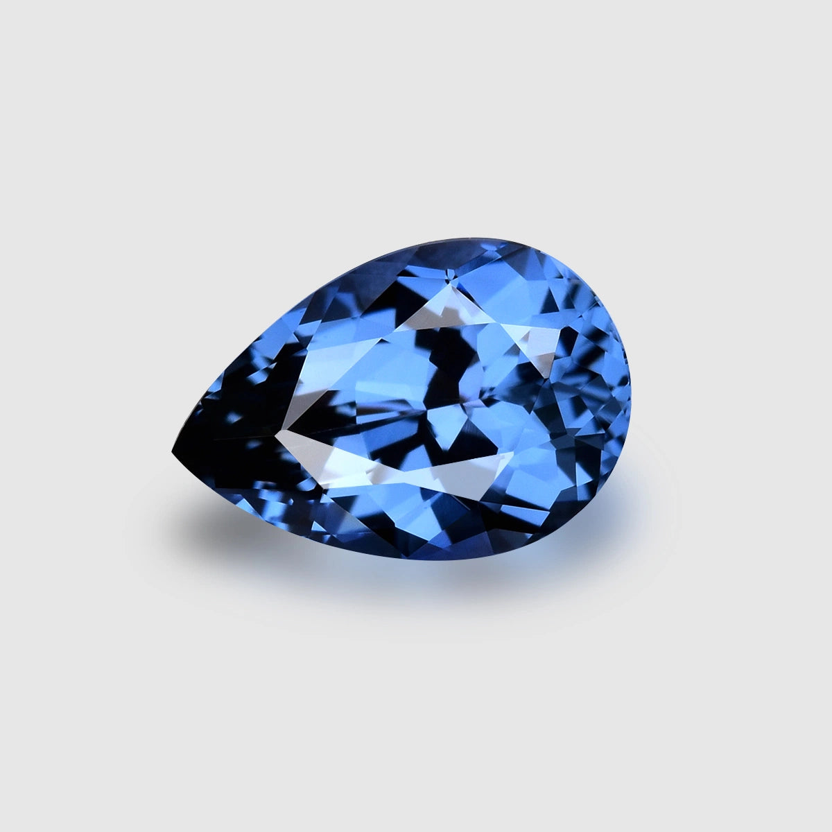 Mesmerising, custom pear-cut, fiery neon purplish blue spinel.