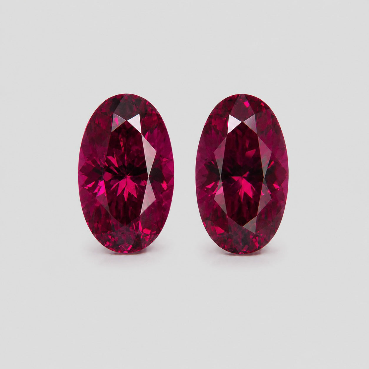 Matching pair precision-cut purplish red Mahenge garnets.