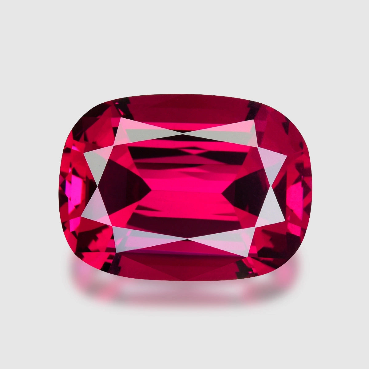 Loupe Clean, precision cushion-cut purplish red Umbalite garnet.