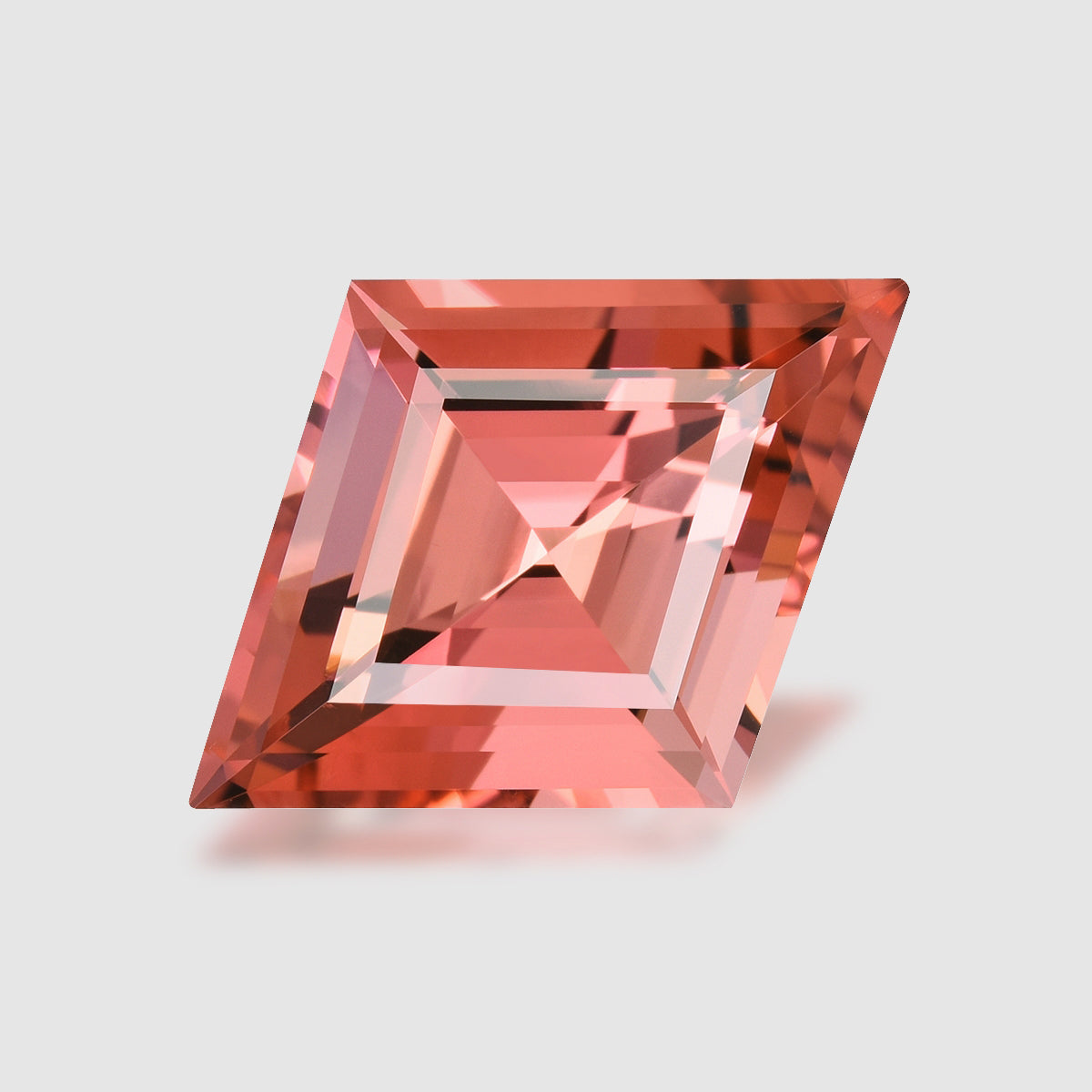 Rhomboid-cut neon orangey pink tourmaline.