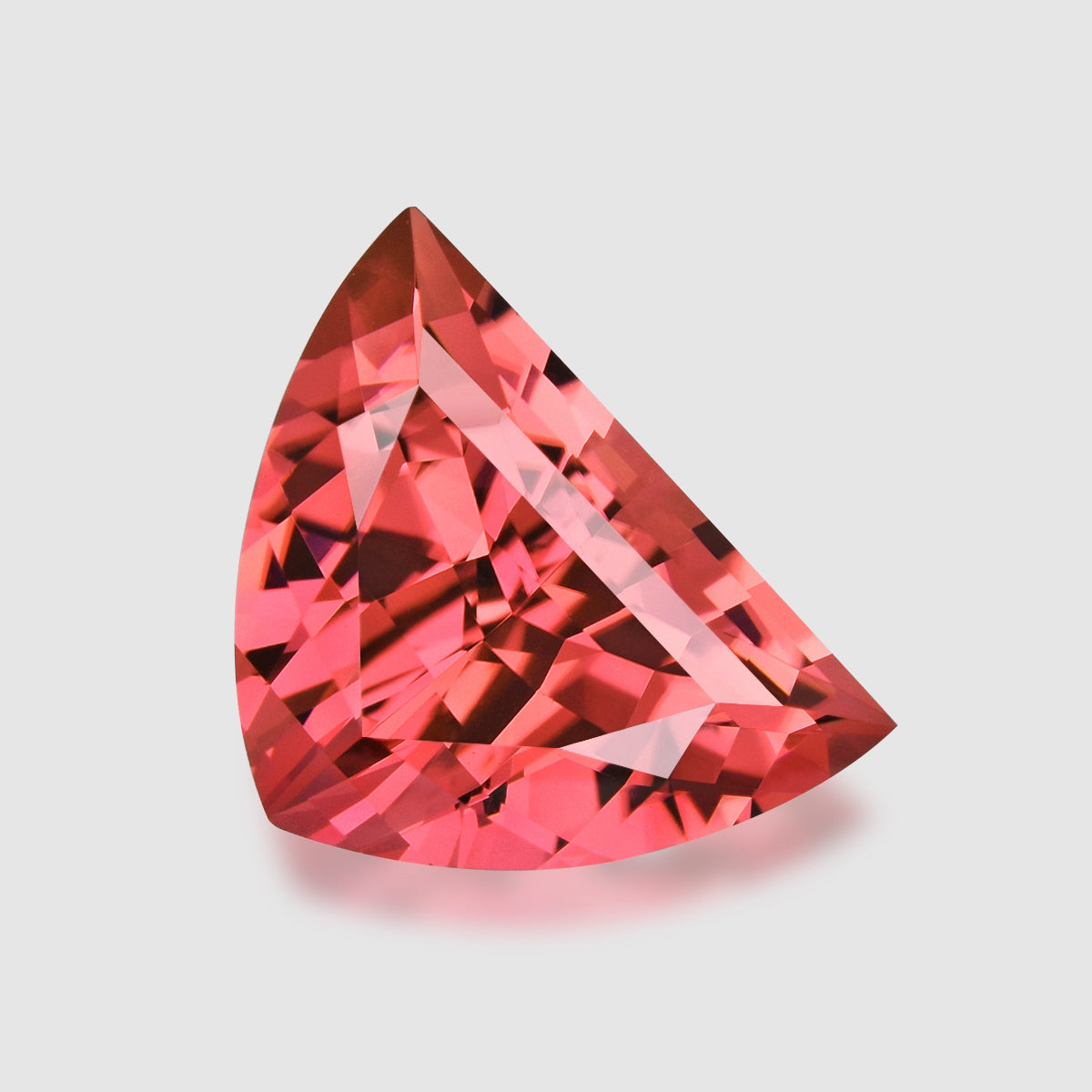 Custom fancy shield-cut, orangey pink tourmaline.
