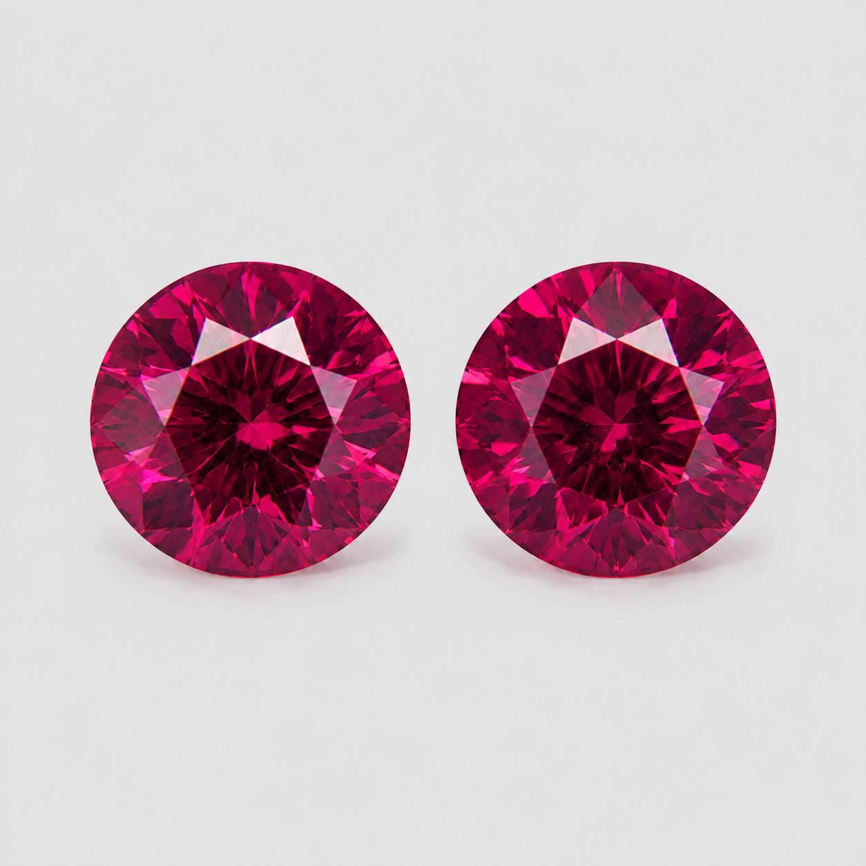 Matching pair precision-cut pinkish red Mahenge garnets.