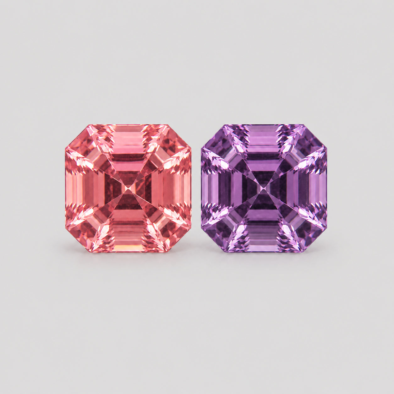 Precision-cut reverse pair pink & purple Mahenge spinel.
