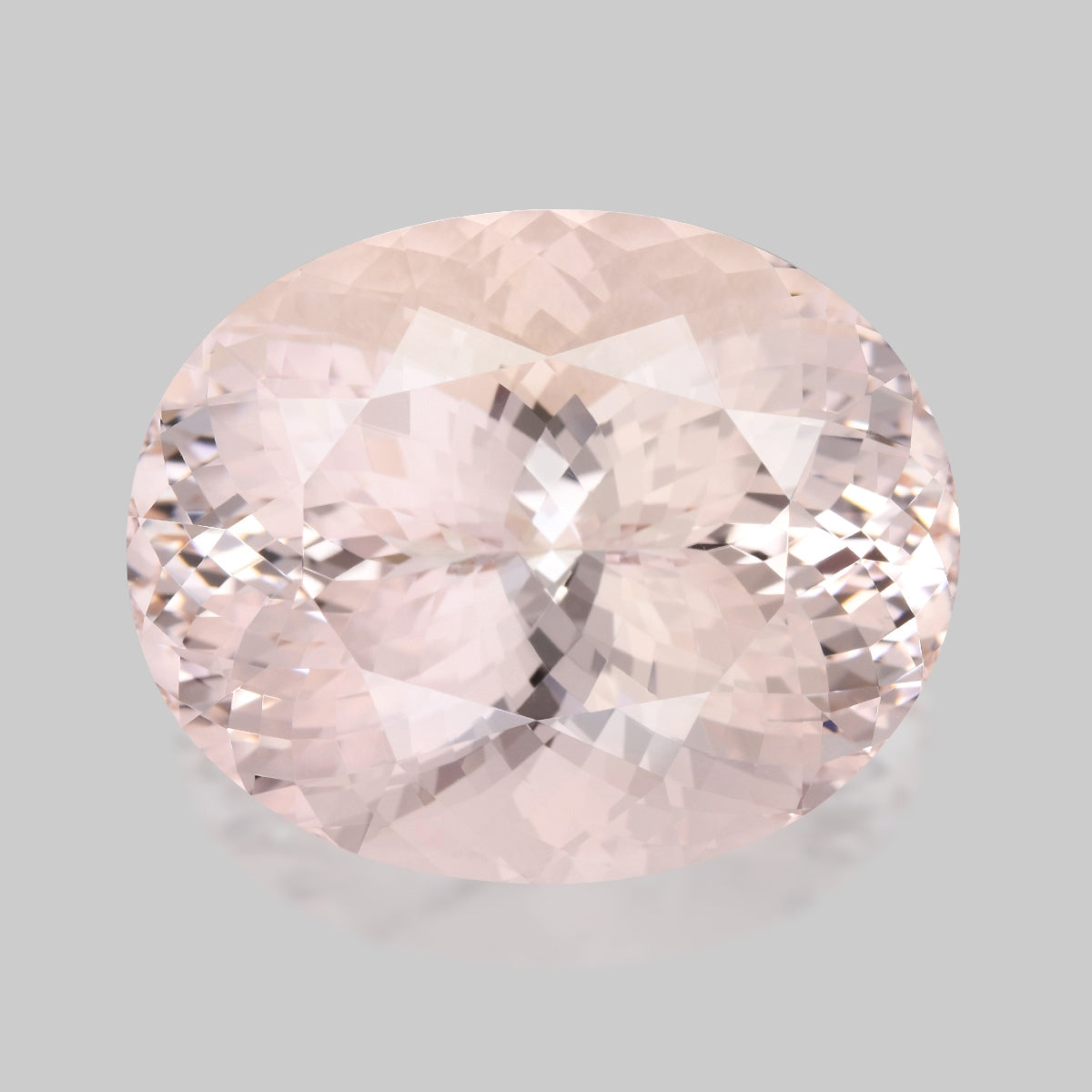 Flawless, precision oval-cut pinkish peach morganite.