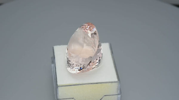 Flawless, precision oval-cut pinkish peach morganite.