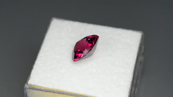 Custom precision-cut pinkish red rhodolite garnet.