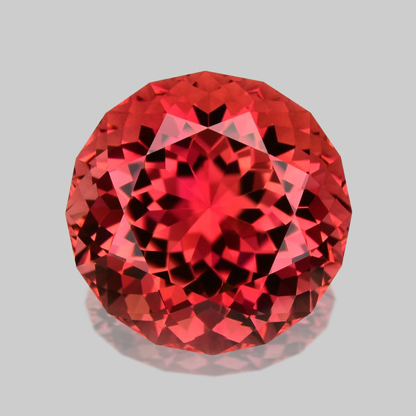 Brilliant custom round-cut Namibian orangey pink tourmaline.